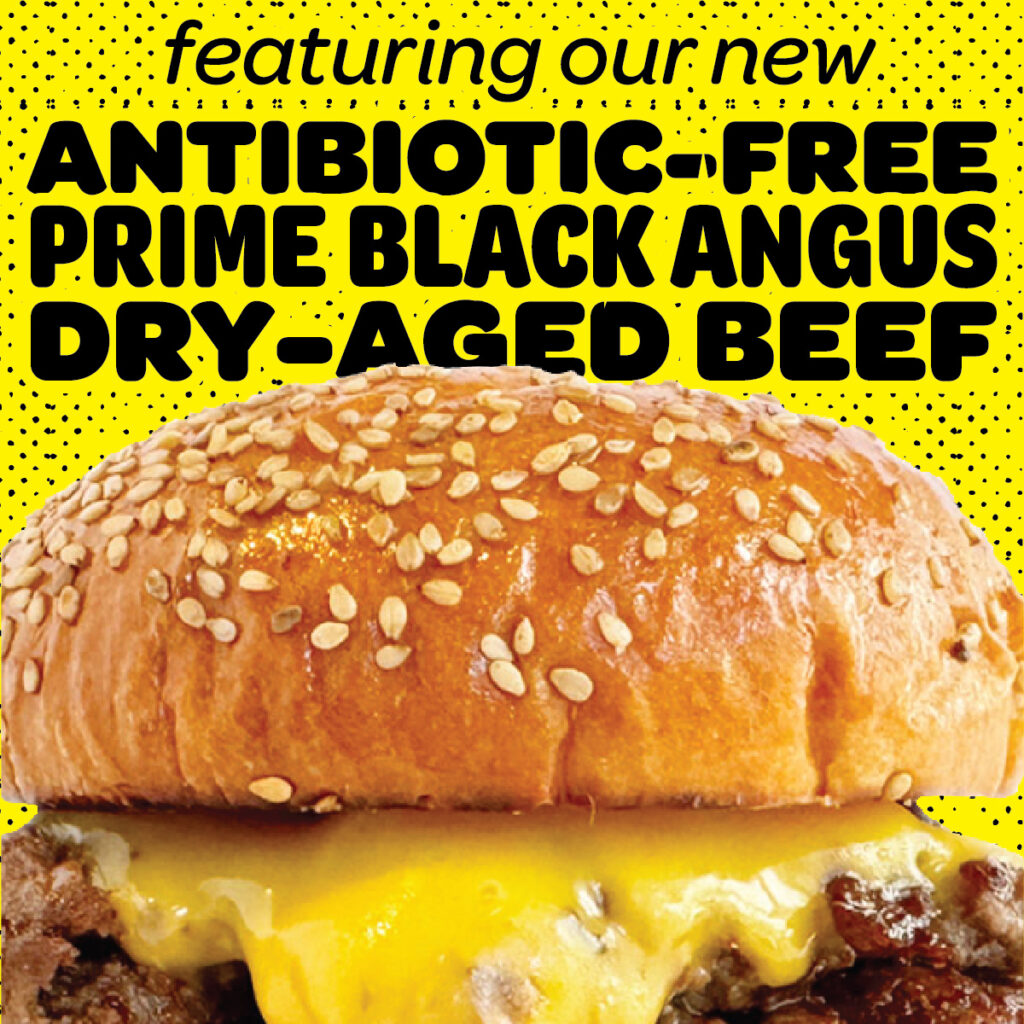 Close-up of Bareburger’s signature sesame seed bun burger featuring antibiotic-free prime Black Angus dry-aged beef and melted cheddar cheese, promoting one of the best burgers in New York City on a bold yellow background